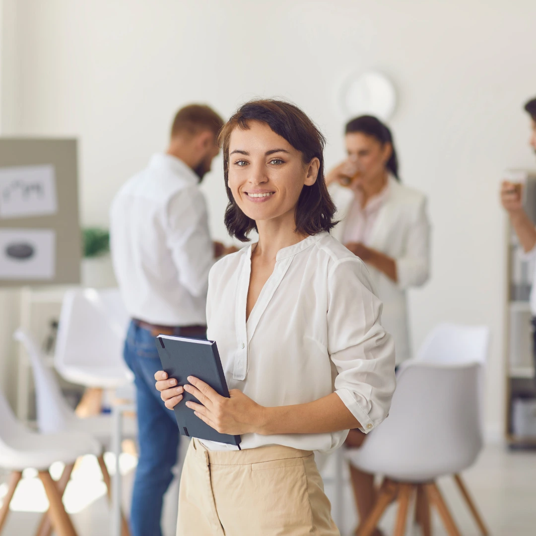 Standing young woman working in a corporate